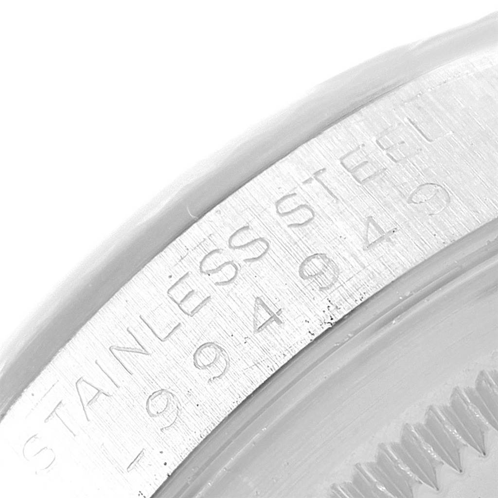 This close-up image shows the stainless steel part of the case back of a Rolex Datejust 16234 Men's Stainless Steel White Dial 16234 Men's Stainless Steel White Dial watch.