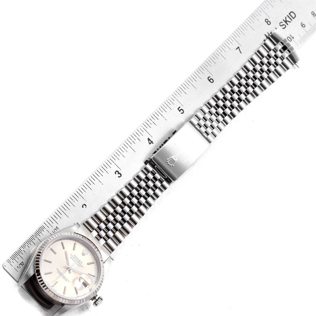 The image shows the Rolex Datejust 16234 Men's Stainless Steel White Dial 16234 Men's Stainless Steel White Dial watch laid flat, with a ruler measuring the length of its bracelet.