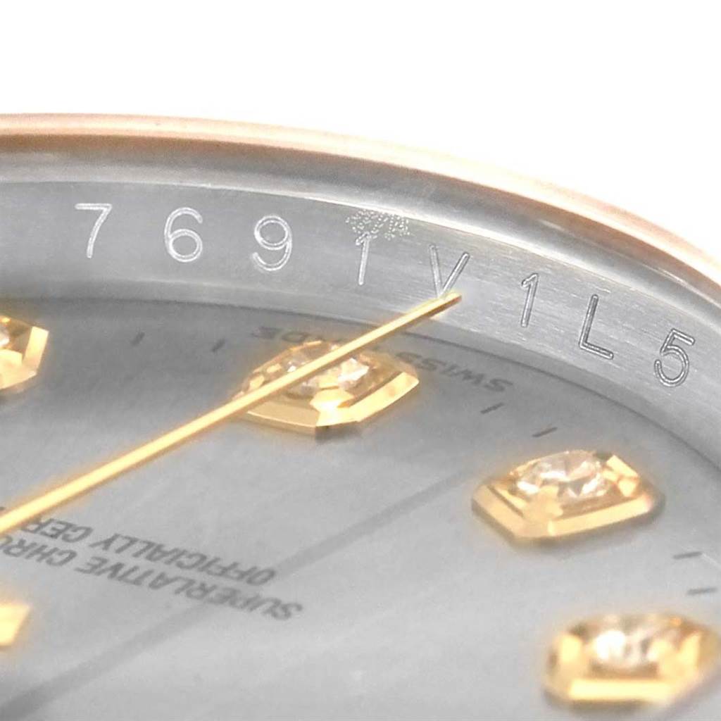 This image shows a close-up, angled view of the dial and rehaut of a Rolex Datejust 116243 Men's Stainless Steel Grey Dial 116243 Men's Stainless Steel Grey Dial watch, displaying part of the serial number.