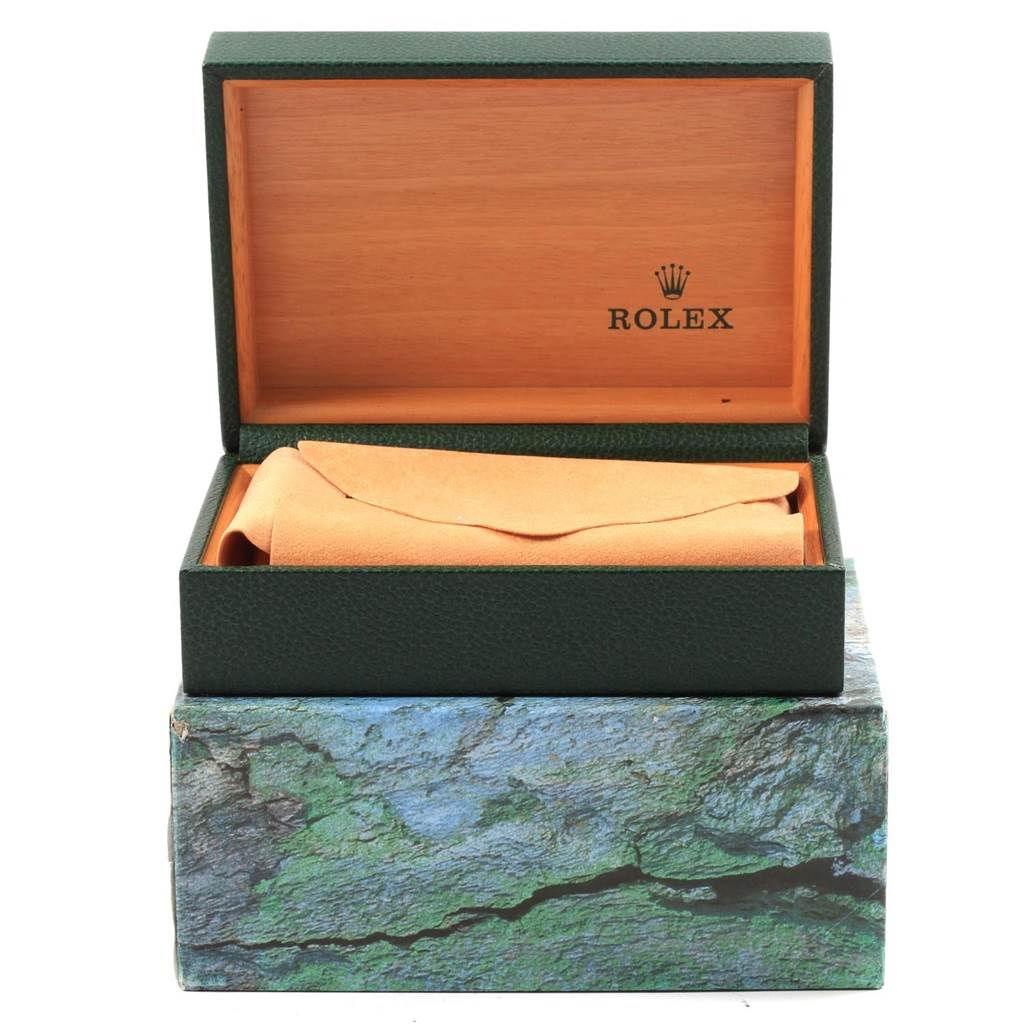 The image shows a Rolex Datejust 16234 Men's Stainless Steel White Dial 16234 Men's Stainless Steel White Dial model watch box with an open lid revealing a beige pillow inside, set on a textured exterior.