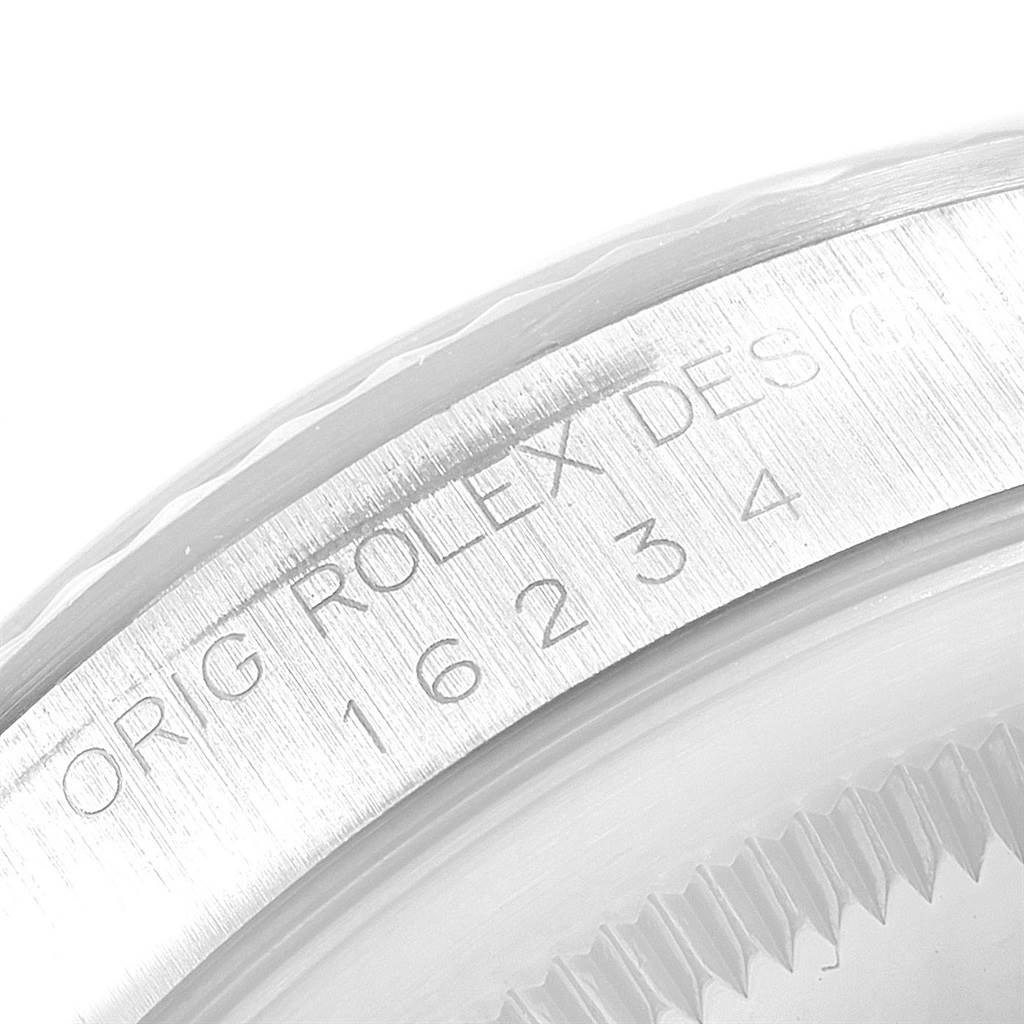 This image shows a close-up of the rehaut and part of the bezel of a Rolex Datejust 16234 Men's Stainless Steel White Dial 16234 Men's Stainless Steel White Dial model, displaying the engraved serial and model numbers.