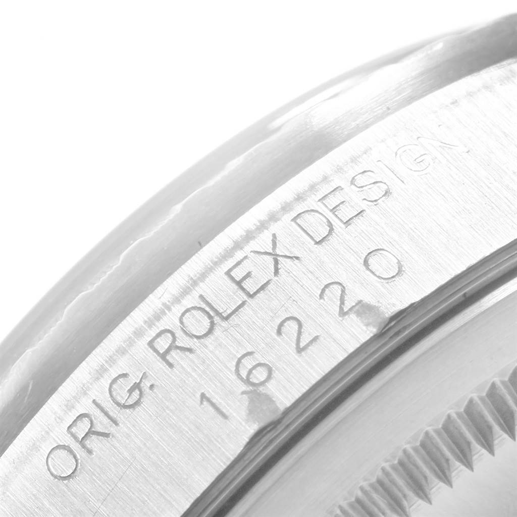 The image shows a close-up view of the edge of the case of a Rolex Datejust 16220 Men
s Stainless Steel Black Dial 16220 Men
s Stainless Steel Black Dial watch, displaying the serial and model numbers.
