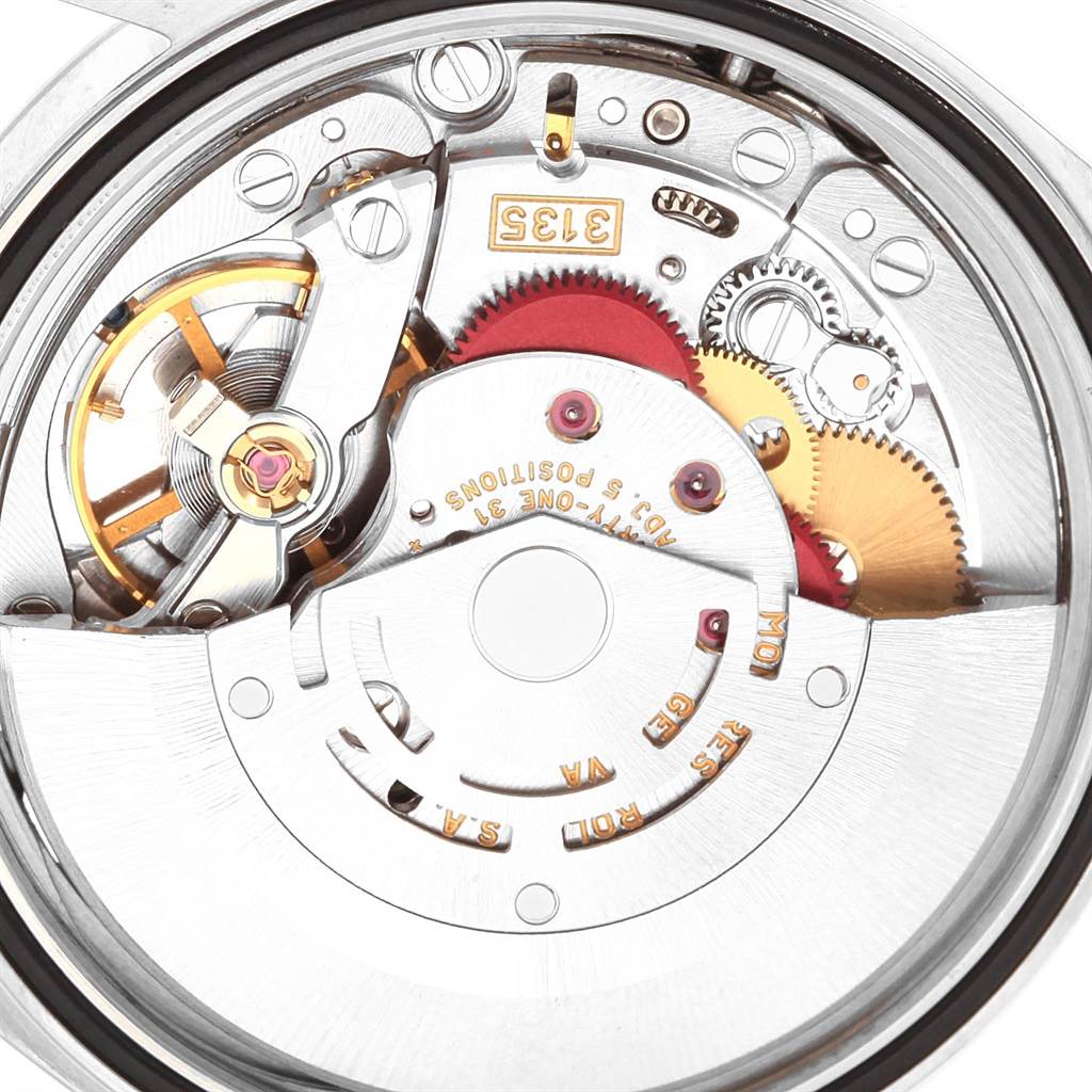 A close-up view of the inner mechanical movement mechanism of a Rolex Datejust 16220 Men
s Stainless Steel Black Dial 16220 Men
s Stainless Steel Black Dial watch is shown, highlighting gears, springs, and inscriptions.