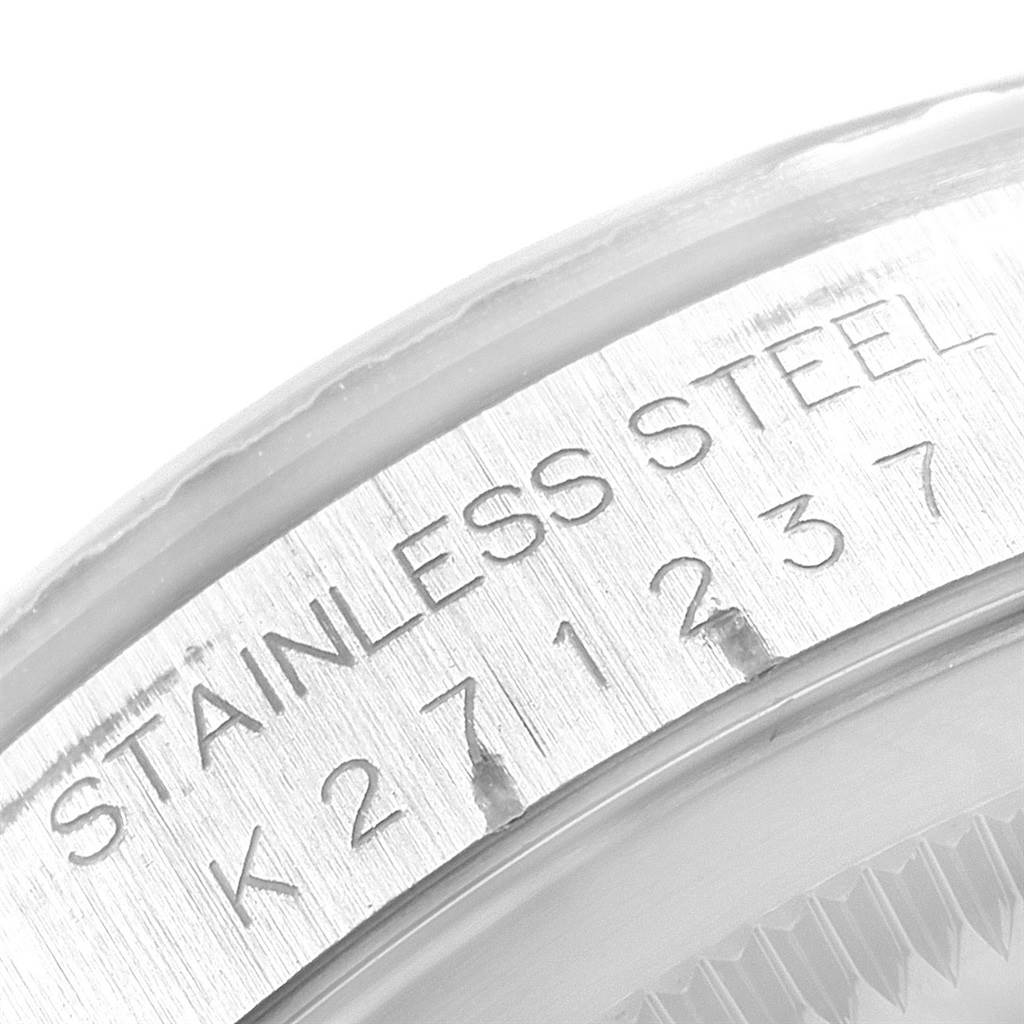 The image shows a close-up angle of the model and serial number engraving on the stainless steel case of a Rolex Datejust 16220 Men
s Stainless Steel Black Dial 16220 Men
s Stainless Steel Black Dial watch.