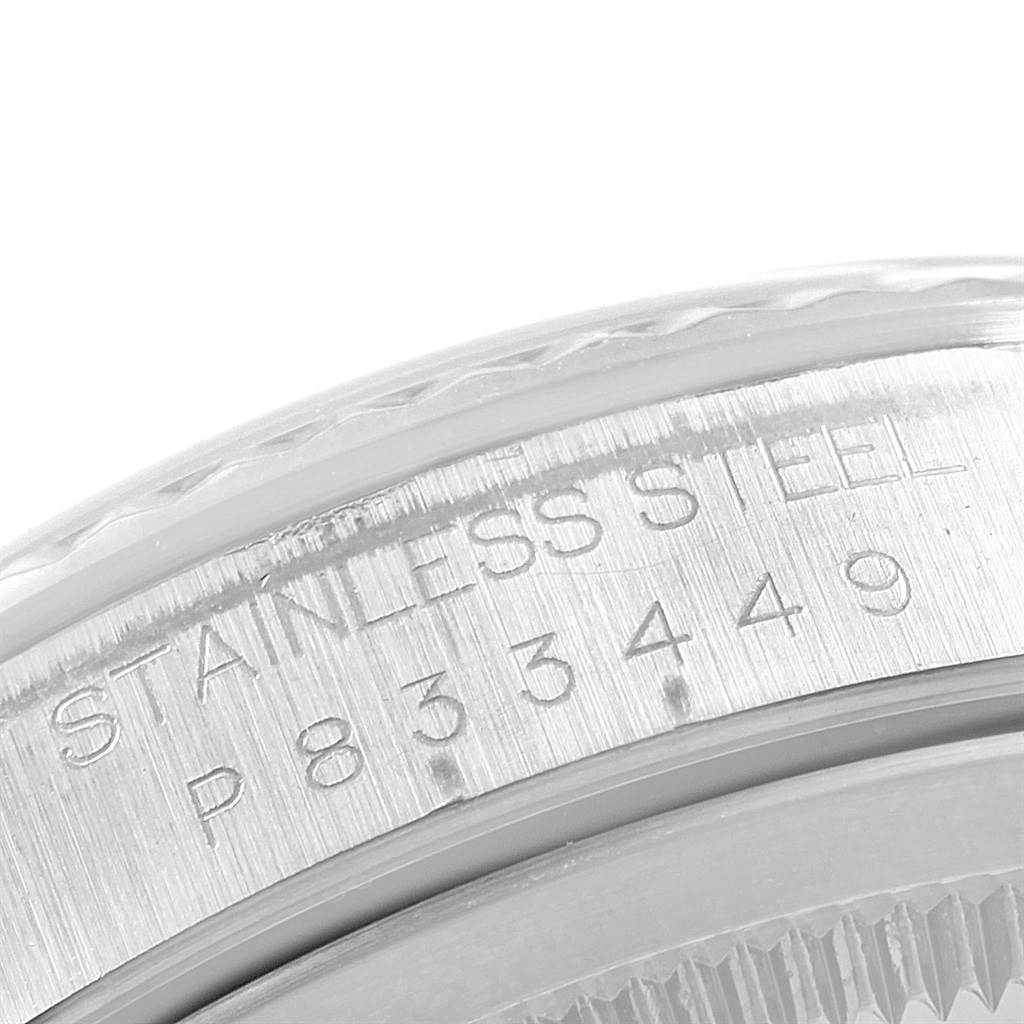 The image shows a close-up of the side of a Rolex Datejust 16234 Men's Stainless Steel Blue Dial 16234 Men's Stainless Steel Blue Dial watch, highlighting the engravings on its stainless steel case.