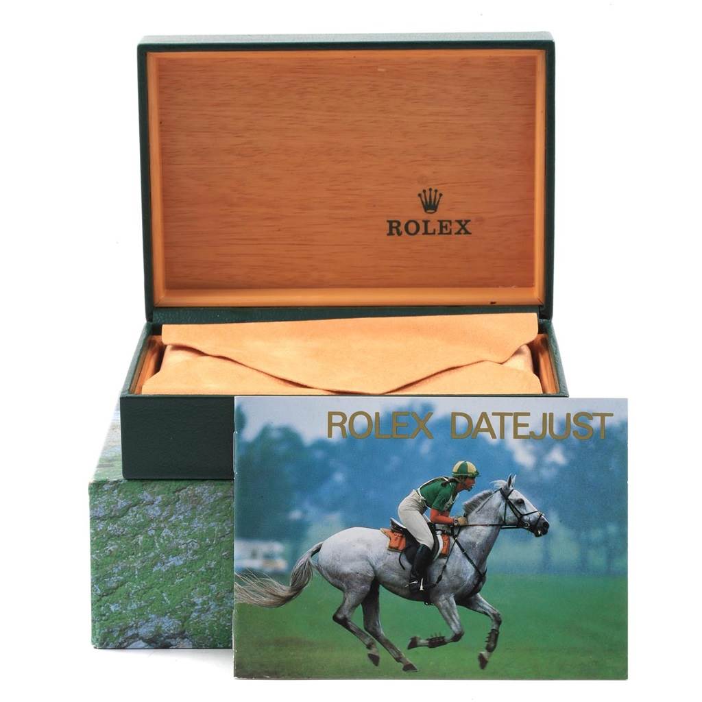 This image shows an open Rolex Datejust 16234 Men's Stainless Steel Blue Dial 16234 Men's Stainless Steel Blue Dial watch box with a booklet placed in front.