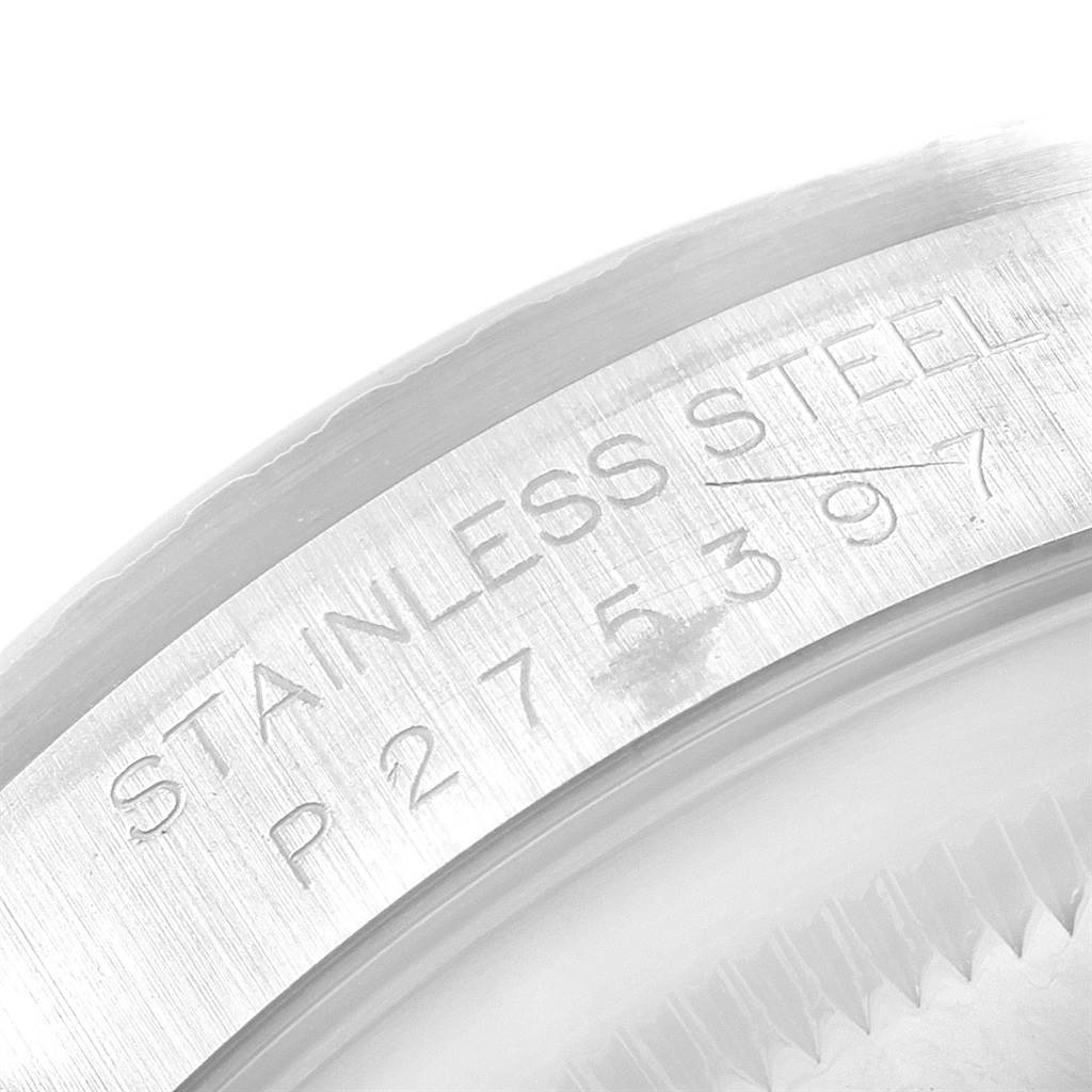 This image shows a macro view of the stainless steel casing of a Rolex Datejust 16220 Men's Stainless Steel White Dial 16220 Men's Stainless Steel White Dial, featuring its serial number.