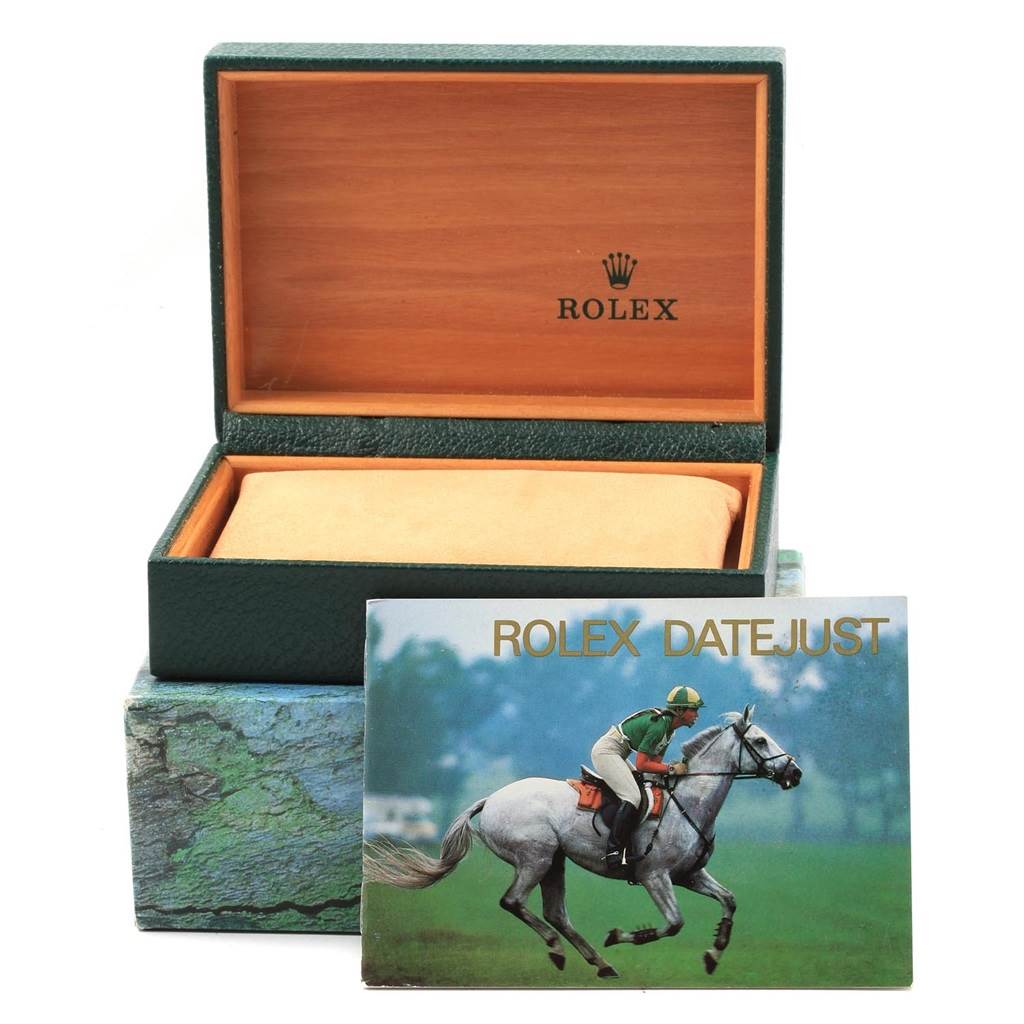 The image shows a Rolex Datejust 16220 Men's Stainless Steel White Dial 16220 Men's Stainless Steel White Dial watch box with its interior and an accompanying booklet featuring a horse rider.
