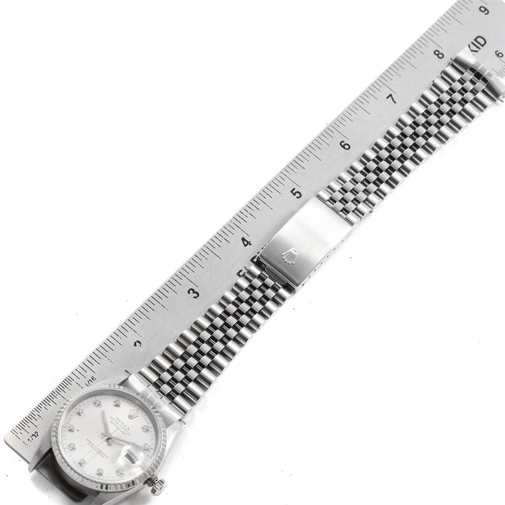 This image shows a horizontal view of the Rolex Datejust 16234 Men's Stainless Steel Silver Dial 16234 Men's Stainless Steel Silver Dial watch, focusing on its face, jubilee bracelet, and clasp, alongside a ruler.