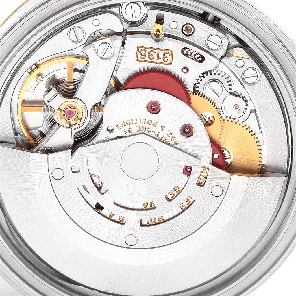 This image shows a close-up view of the movement of a Rolex Datejust 16233 Men's Steel and Gold (two tone) Mother of Pearl Dial 16233 Men's Steel and Gold (two tone) Mother of Pearl Dial watch, revealing its intricate mechanical components.