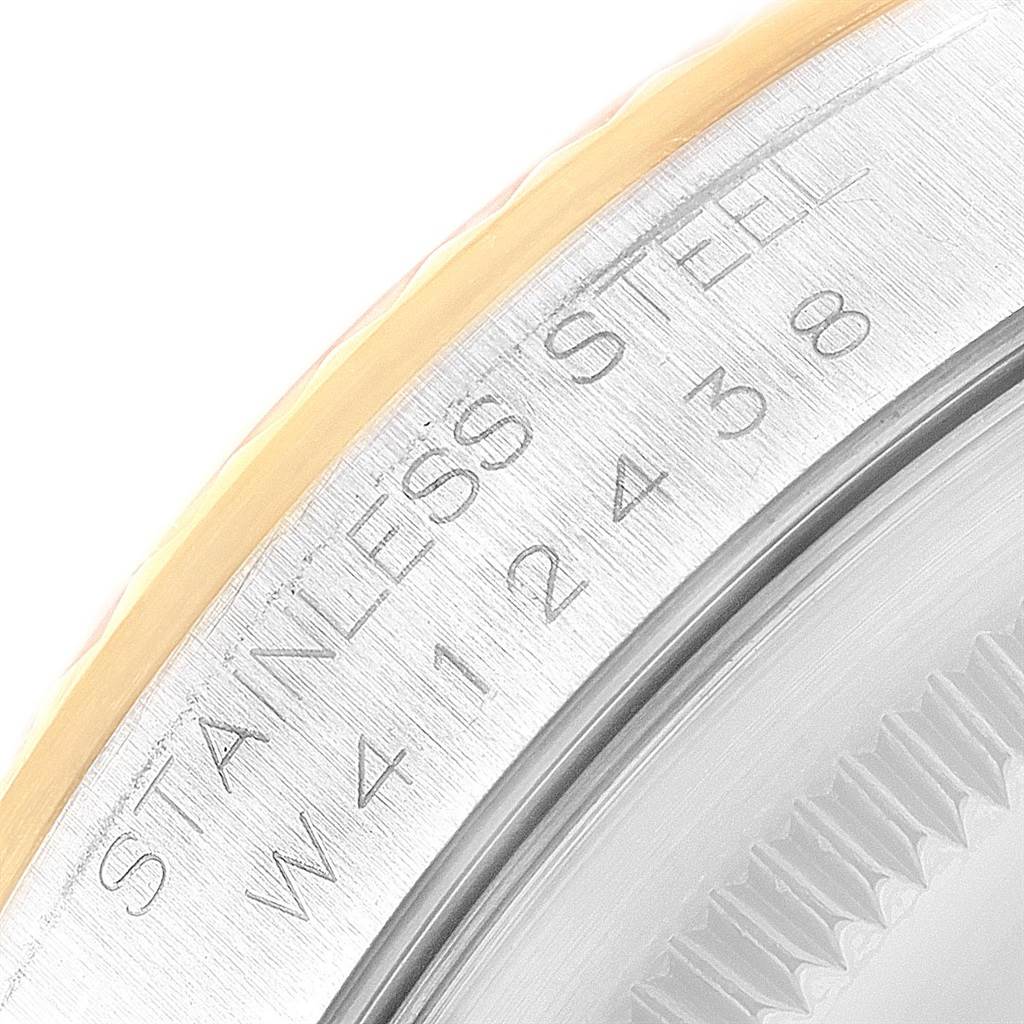 This close-up image shows the stainless steel case back and part of the fluted bezel of the Rolex Datejust 16233 Men's Steel and Gold (two tone) Mother of Pearl Dial 16233 Men's Steel and Gold (two tone) Mother of Pearl Dial watch.