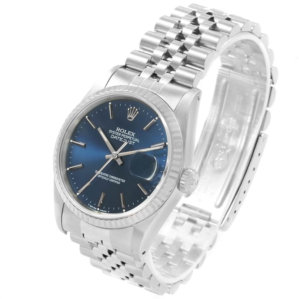 The image shows a Rolex Datejust 16234 Men's Stainless Steel Blue Dial 16234 Men's Stainless Steel Blue Dial watch at a three-quarter angle, highlighting its blue dial, fluted bezel, and jubilee bracelet.