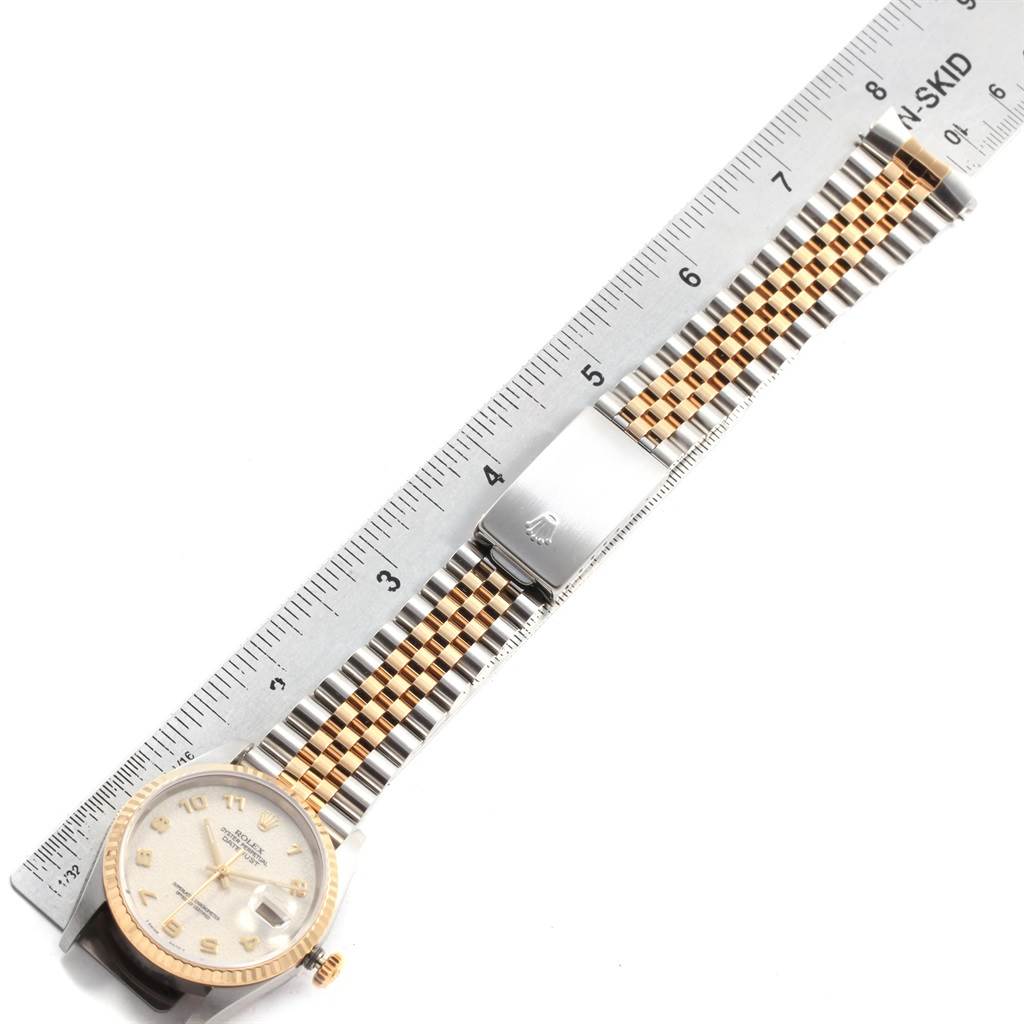 The image shows a flat-lay of the Rolex Datejust 16233 Men's Steel and Gold (two tone) Beige Dial 16233 Men's Steel and Gold (two tone) Beige Dial watch displaying its face, bracelet, and clasp alongside a ruler.