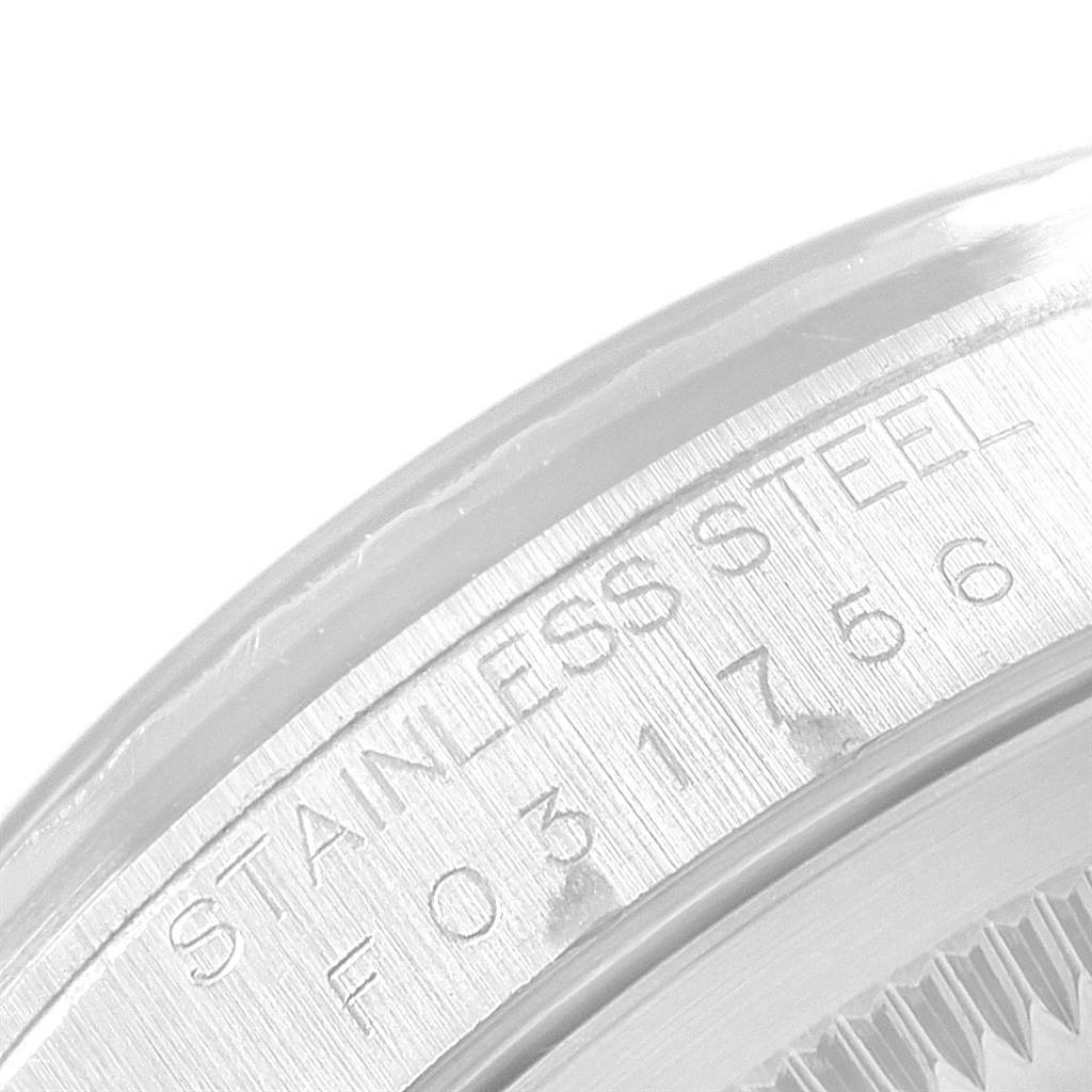 The image shows a close-up of the case back and edge bezel of a Rolex Datejust 16220 Men's Stainless Steel Pink Dial 16220 Men's Stainless Steel Pink Dial watch, highlighting the "Stainless Steel" engraving.