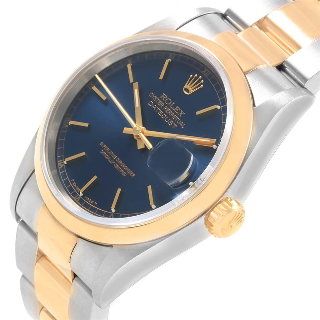 The Rolex Datejust 16203 Men
s Steel and Gold (two tone) Blue Dial 16203 Men
s Steel and Gold (two tone) Blue Dial watch is shown at an angle highlighting the dial, bezel, crown, and part of the bracelet.