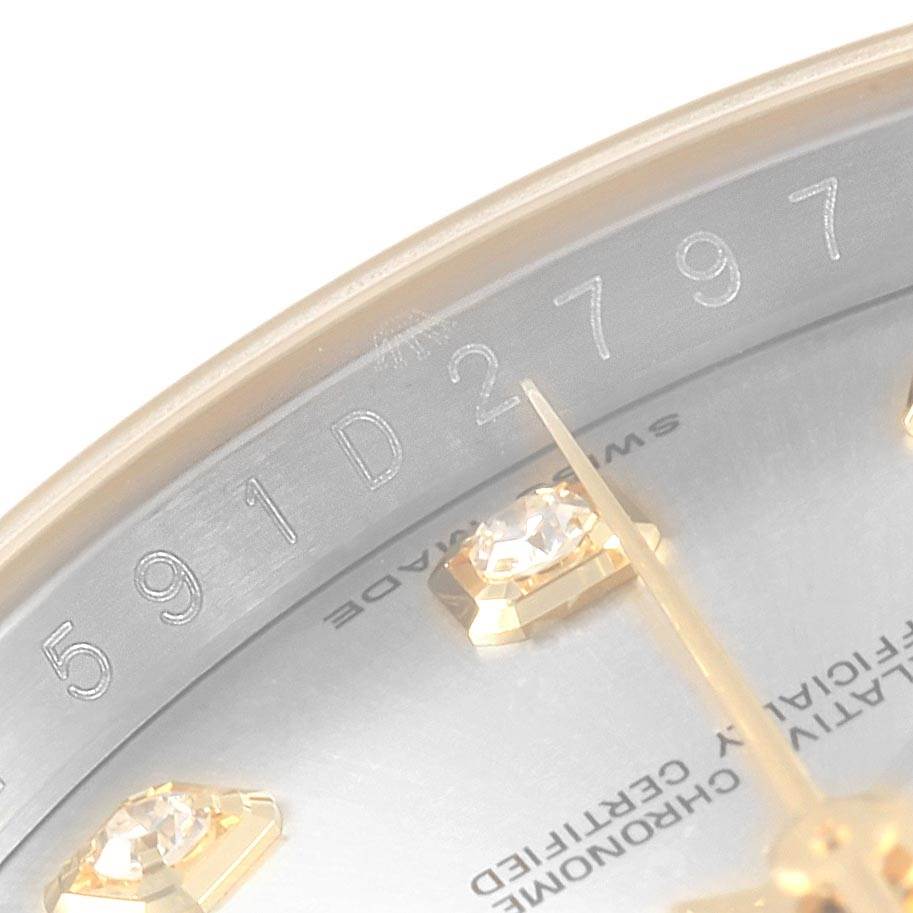 This close-up image of the Rolex Datejust 116233 Men's Stainless Steel Silver Dial 116233 Men's Stainless Steel Silver Dial shows part of the dial with diamond markers and the engraved serial number.
