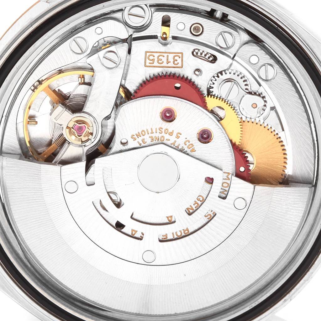 This image shows the intricate internal mechanism of a Rolex Datejust 16233 Men's Steel and Gold (two tone) Champagne Dial 16233 Men's Steel and Gold (two tone) Champagne Dial watch, focusing on the gears and movement from a top-down angle.
