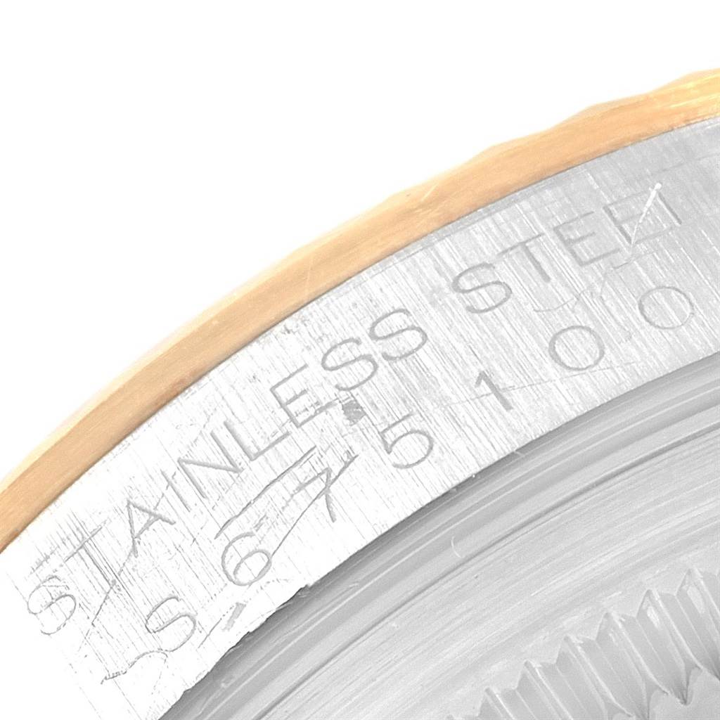 This image shows a macro view of the outer edge and engraving on a Rolex Datejust 16233 Men's Steel and Gold (two tone) Champagne Dial 16233 Men's Steel and Gold (two tone) Champagne Dial watch bezel.