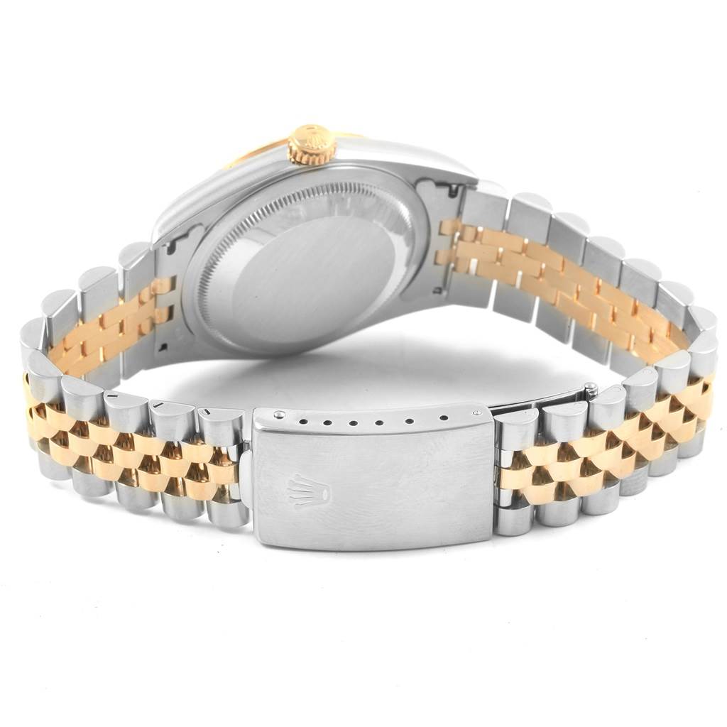 The image shows the back case and bracelet of a Rolex Datejust 16233 Men's Steel and Gold (two tone) Champagne Dial 16233 Men's Steel and Gold (two tone) Champagne Dial watch, featuring a two-tone metal design with a clasp.