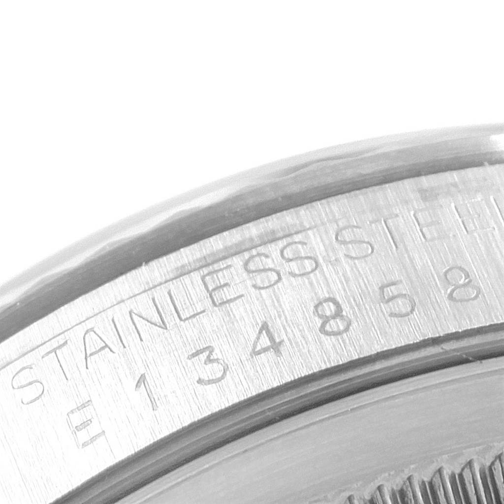 The image shows a close-up of the case back edge with engraved serial number and "STAINLESS STEEL" marking on the Rolex Datejust 16234 Men's Stainless Steel Silver Dial 16234 Men's Stainless Steel Silver Dial watch.