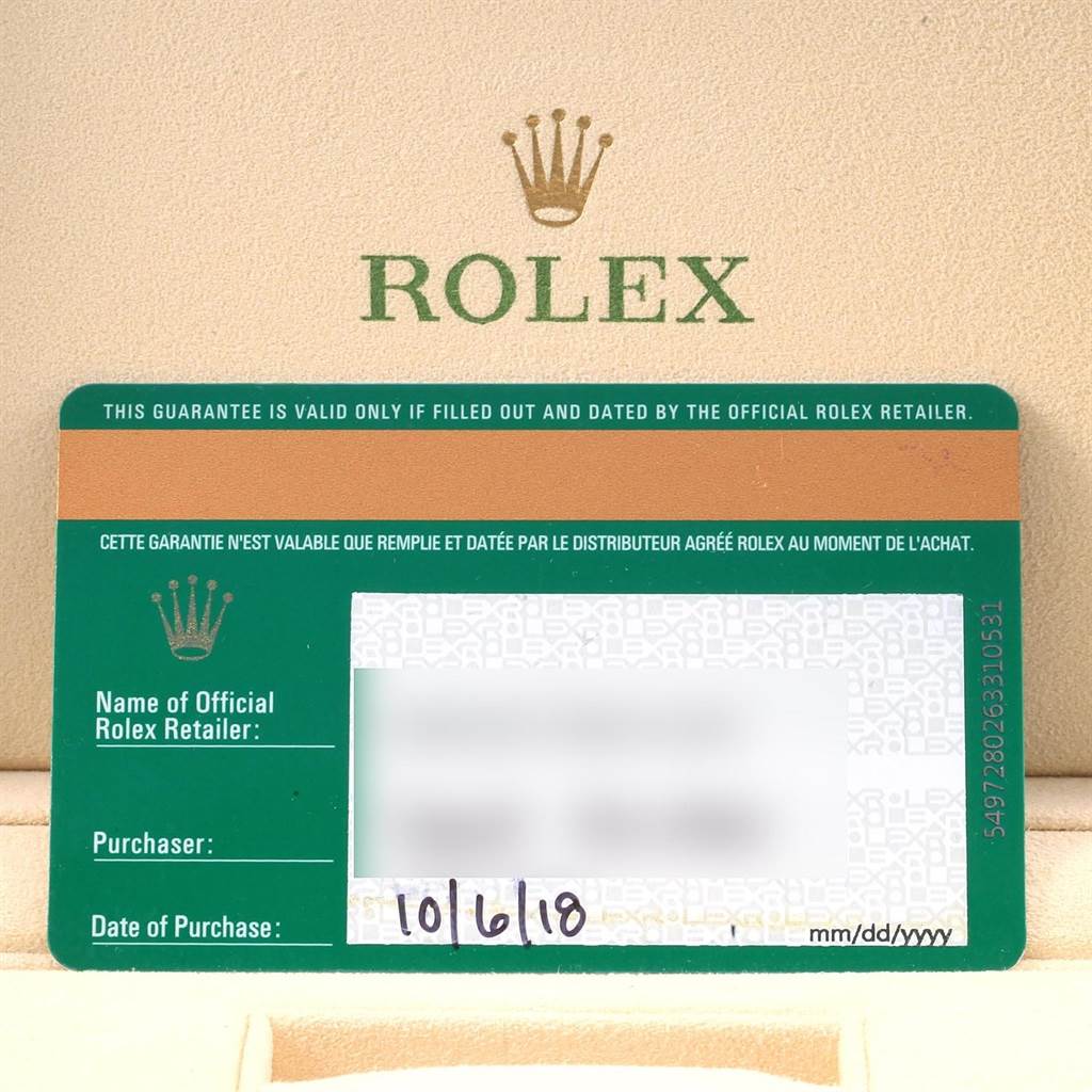 This image shows a guarantee card for a Rolex Datejust 116200 Men
s Stainless Steel Black Dial 116200 Men
s Stainless Steel Black Dial watch placed on a Rolex-branded surface.