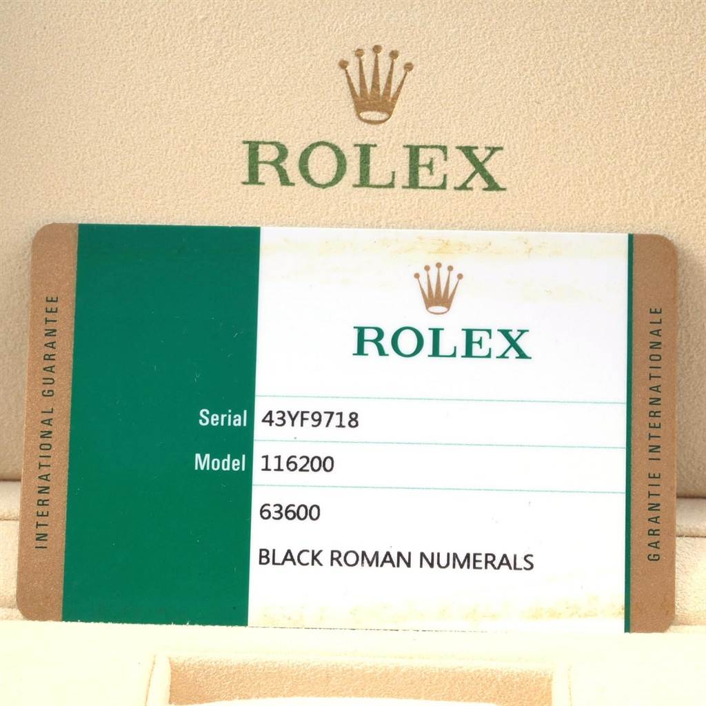 The image shows a Rolex Datejust 116200 Men
s Stainless Steel Black Dial 116200 Men
s Stainless Steel Black Dial model warranty card with serial number and model details.
