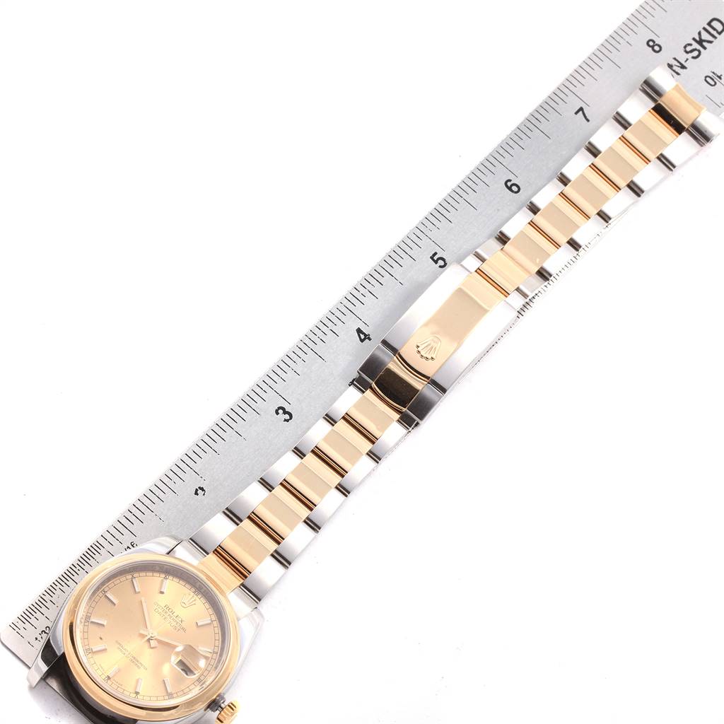 The image shows a Rolex Datejust 116203 Men's Stainless Steel Champagne Dial 116203 Men's Stainless Steel Champagne Dial watch laid flat next to a ruler, highlighting the watch face and bracelet.