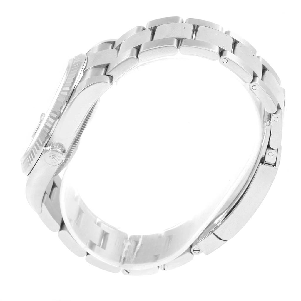 The image shows a Rolex Datejust 116234 Men
s Stainless Steel Black Dial 116234 Men
s Stainless Steel Black Dial watch from the side angle, highlighting the crown and metal bracelet.