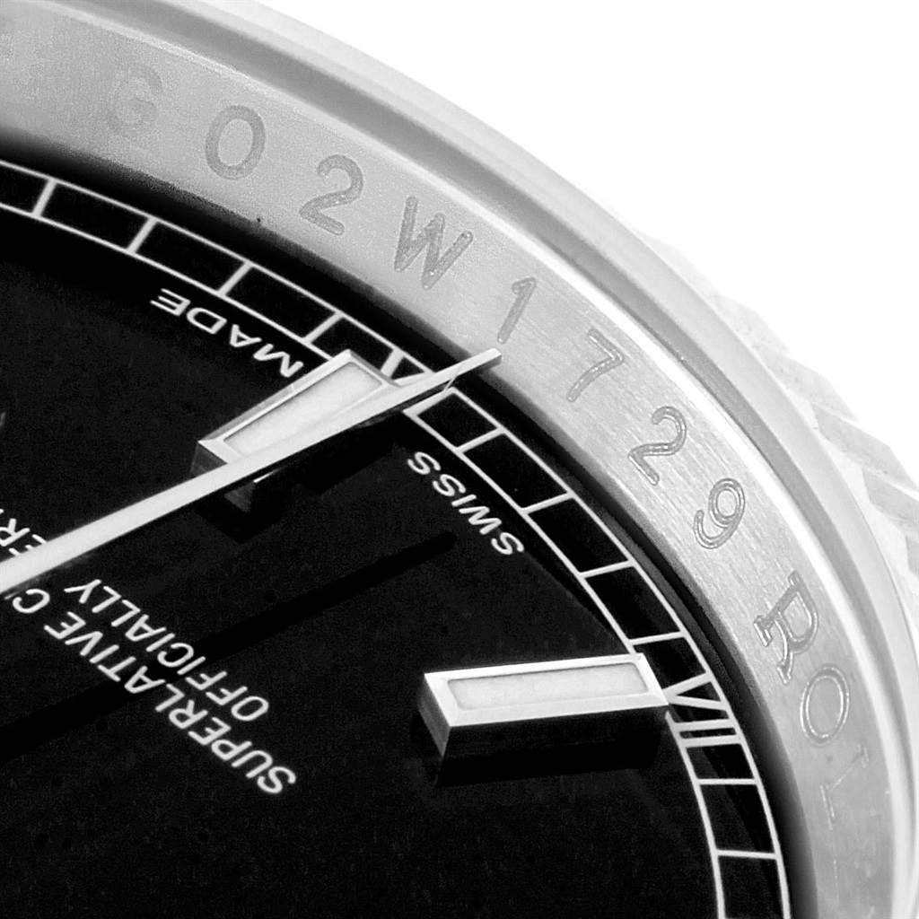 This close-up image shows the partial dial and bezel of a Rolex Datejust 116234 Men
s Stainless Steel Black Dial 116234 Men
s Stainless Steel Black Dial watch, highlighting the hour markers and "Swiss Made" text.