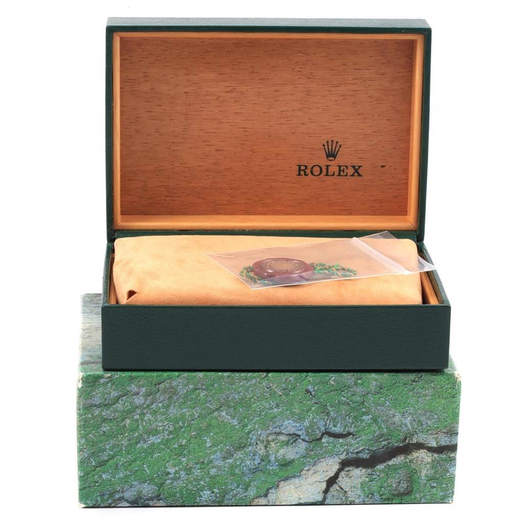 The image shows a Rolex Datejust 16233 Men's Steel and Gold (two tone) Champagne Dial 16233 Men's Steel and Gold (two tone) Champagne Dial watch box with an exterior green design, an interior wood finish, and a protective pouch with accessories inside.