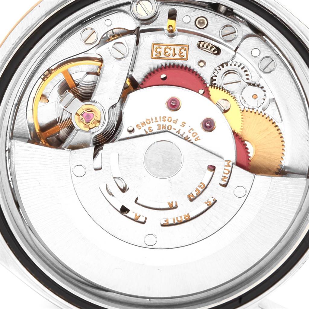 This is a close-up view of the internal mechanism of a Rolex Datejust 16233 Men's Steel and Gold (two tone) Champagne Dial 16233 Men's Steel and Gold (two tone) Champagne Dial watch, showcasing its intricate gears and components.