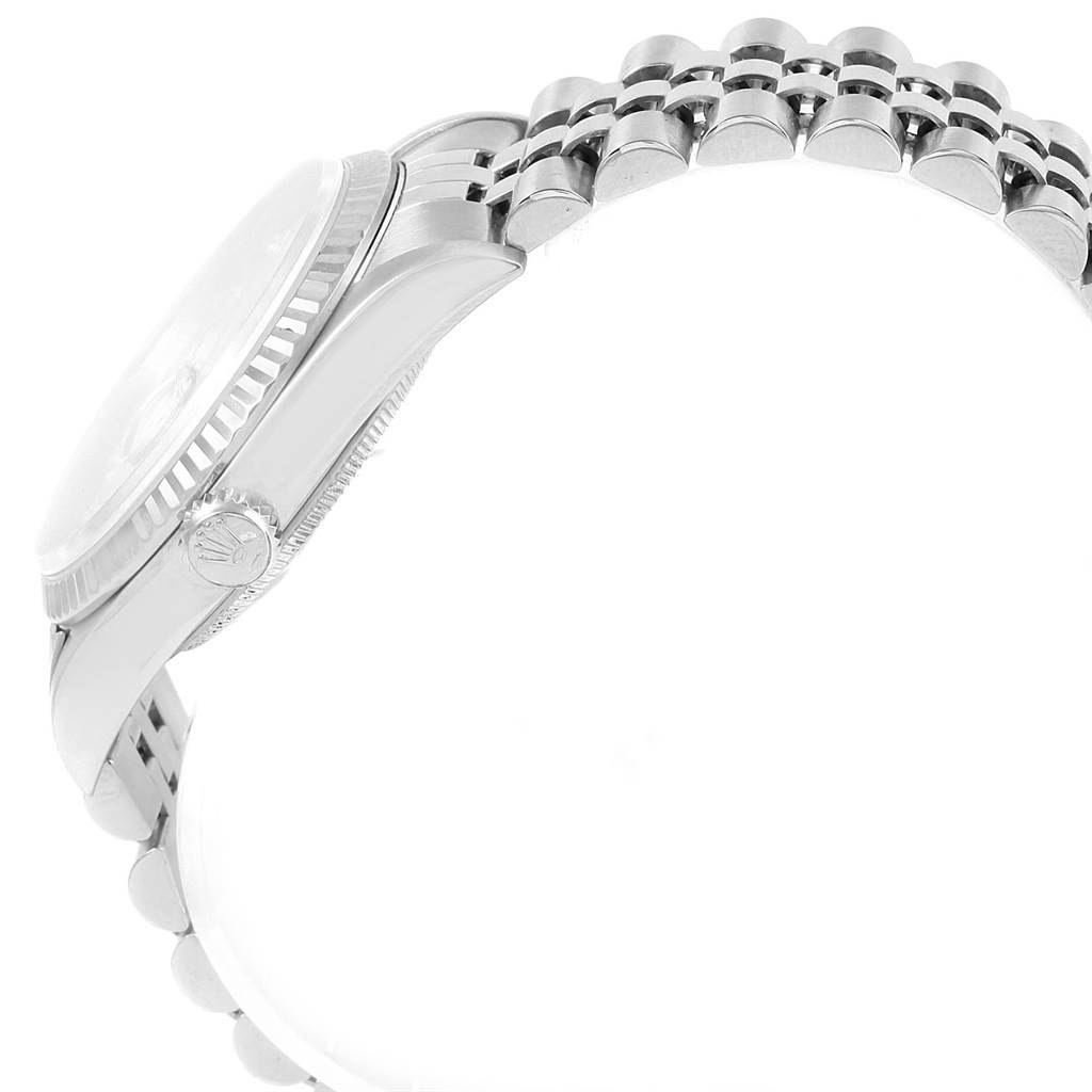 The image shows a side view of the Rolex Datejust 16234 Men
s Stainless Steel Silver Dial 16234 Men
s Stainless Steel Silver Dial watch, highlighting the crown, case, and part of the metal bracelet.