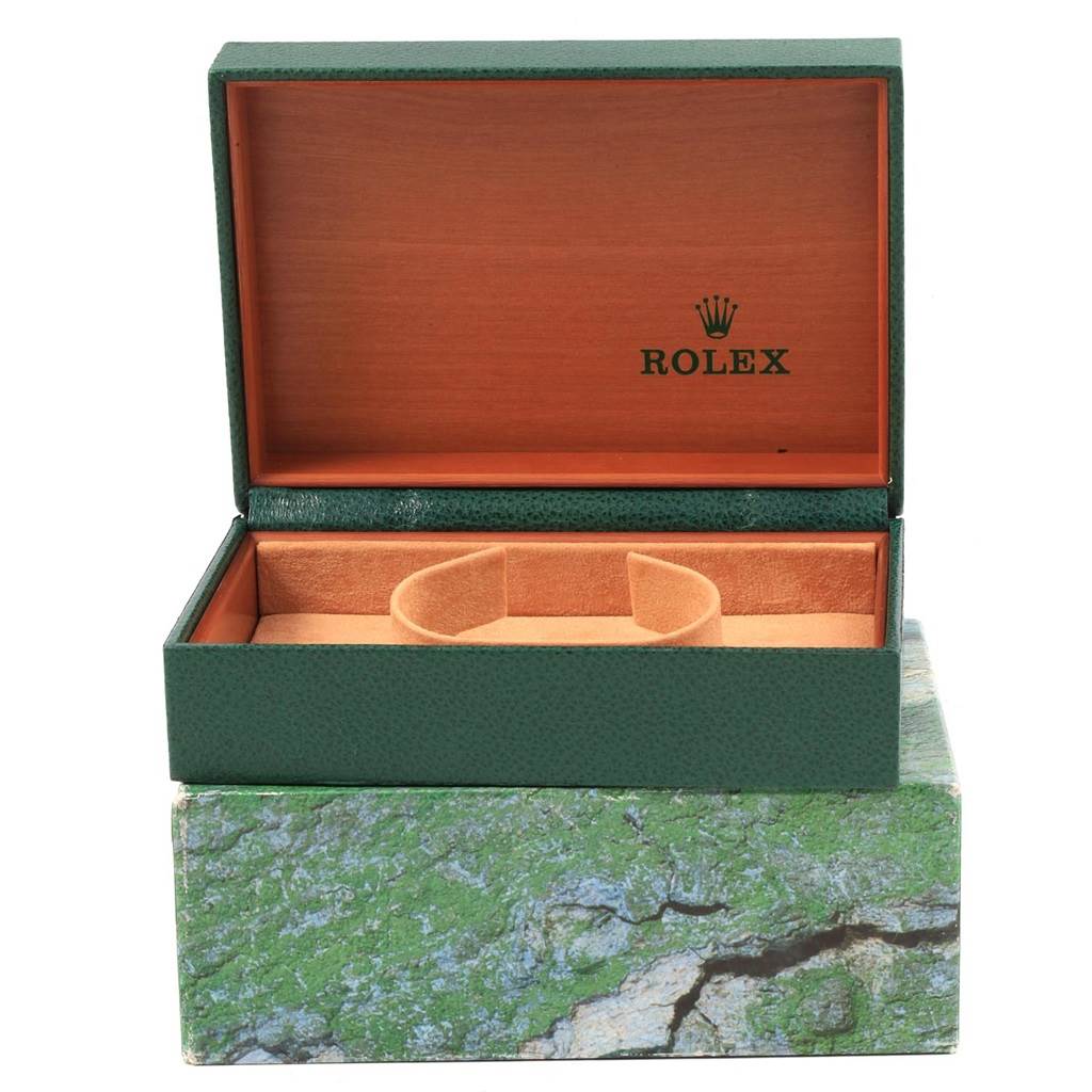 The image shows an open green Rolex box with cushioning inside, typically used for the Datejust model watch.