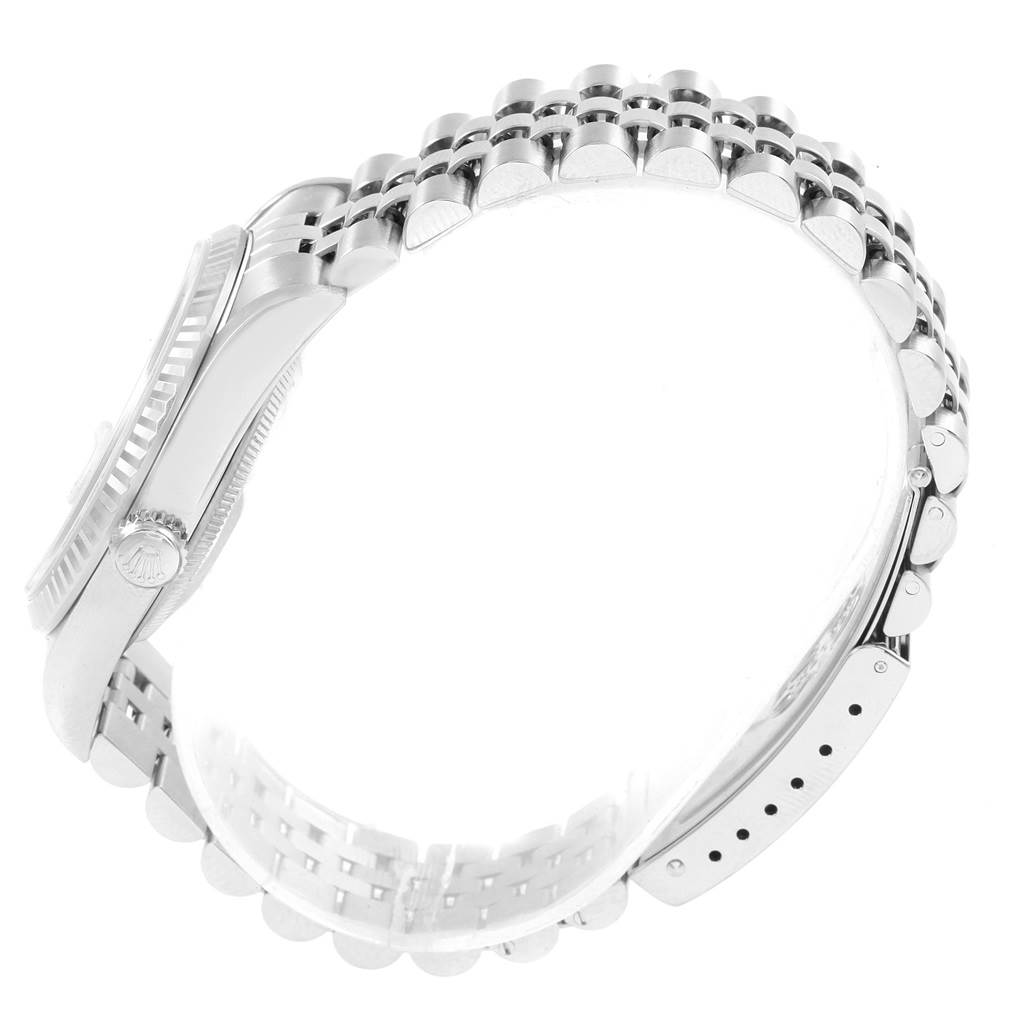 The image shows a side view of the Rolex Datejust 16234 Men's Stainless Steel Silver Dial 16234 Men's Stainless Steel Silver Dial watch featuring its bezel, crown, and bracelet.