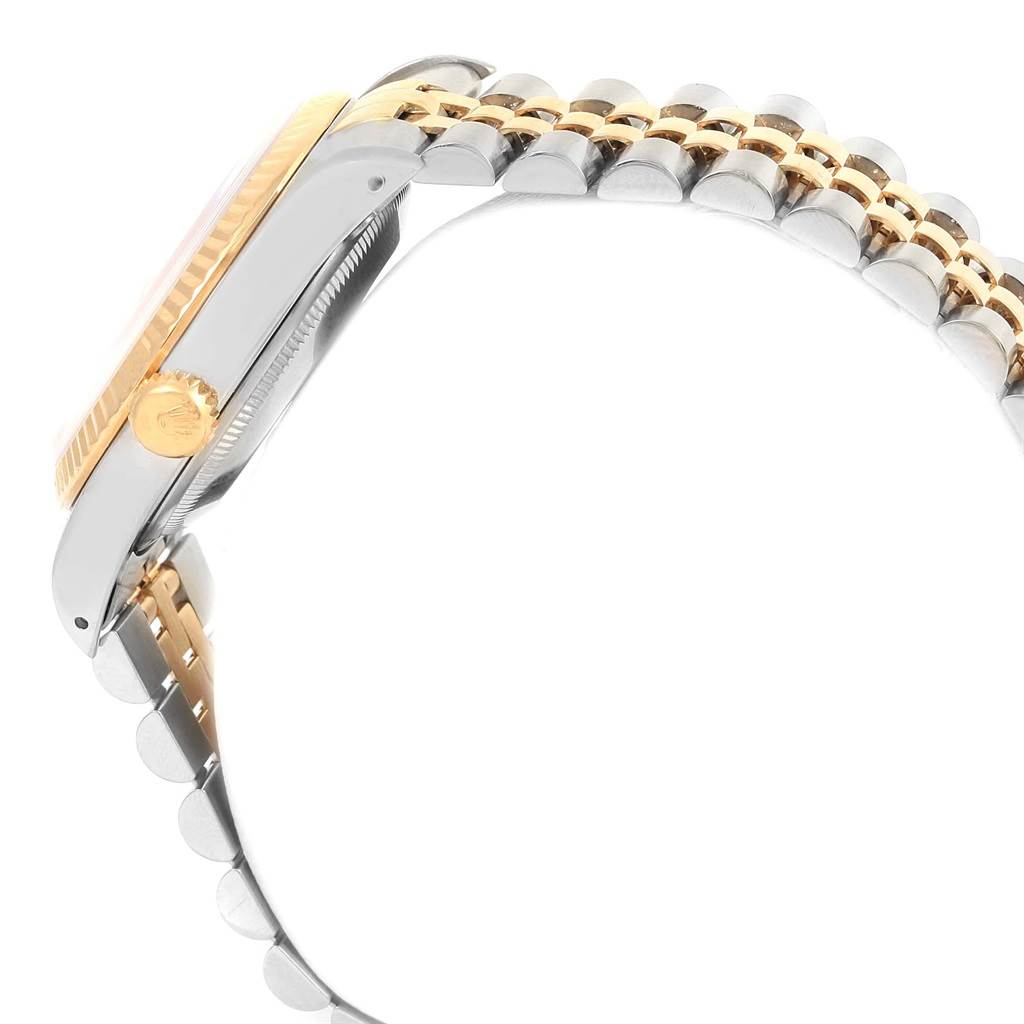 The photo shows a side view of a Rolex Datejust 16233 Men's Steel and Gold (two tone) Champagne Dial 16233 Men's Steel and Gold (two tone) Champagne Dial watch, highlighting its crown, case, and two-tone bracelet.