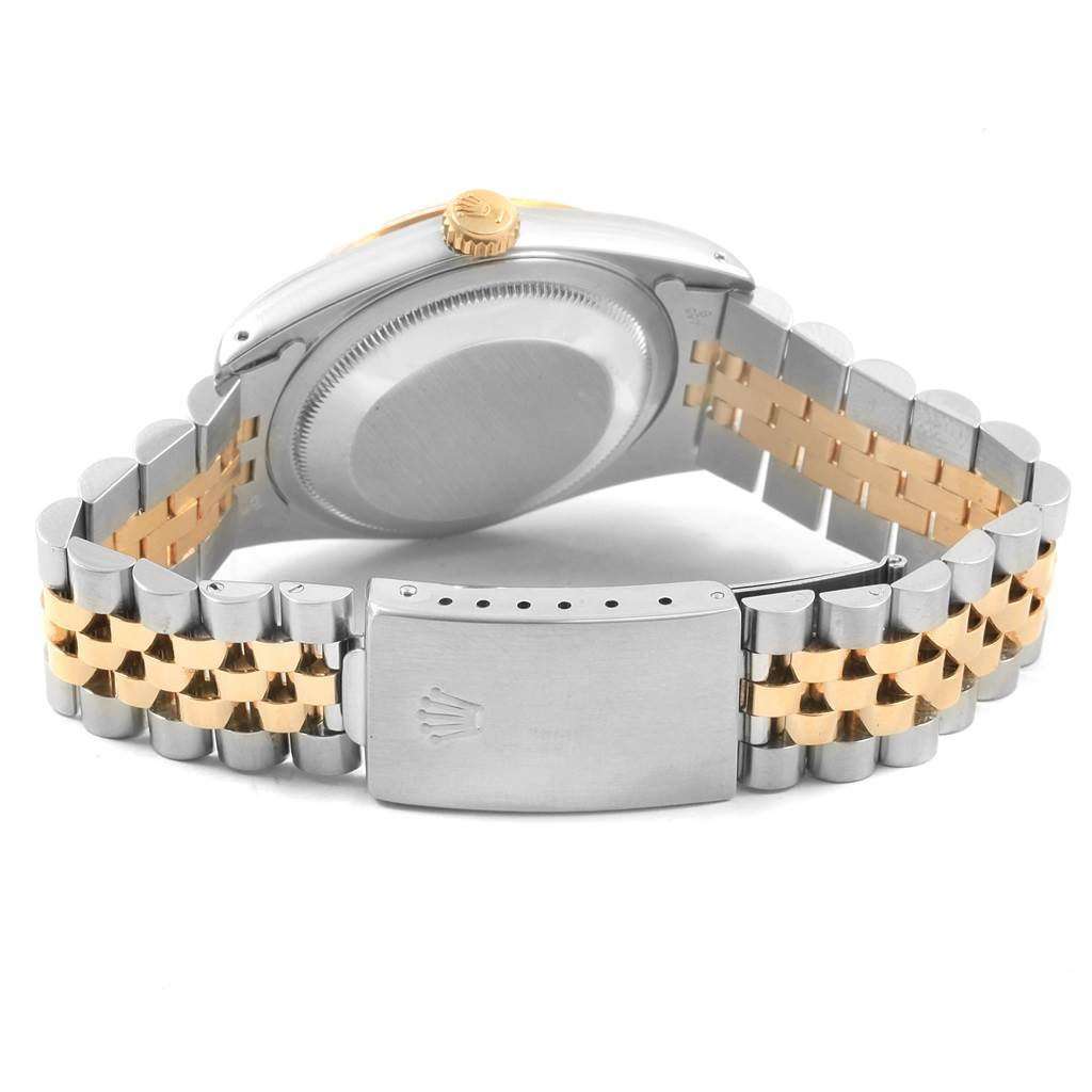 This image shows the back case, crown, and bracelet clasp of a Rolex Datejust 16233 Men's Steel and Gold (two tone) Champagne Dial 16233 Men's Steel and Gold (two tone) Champagne Dial watch.