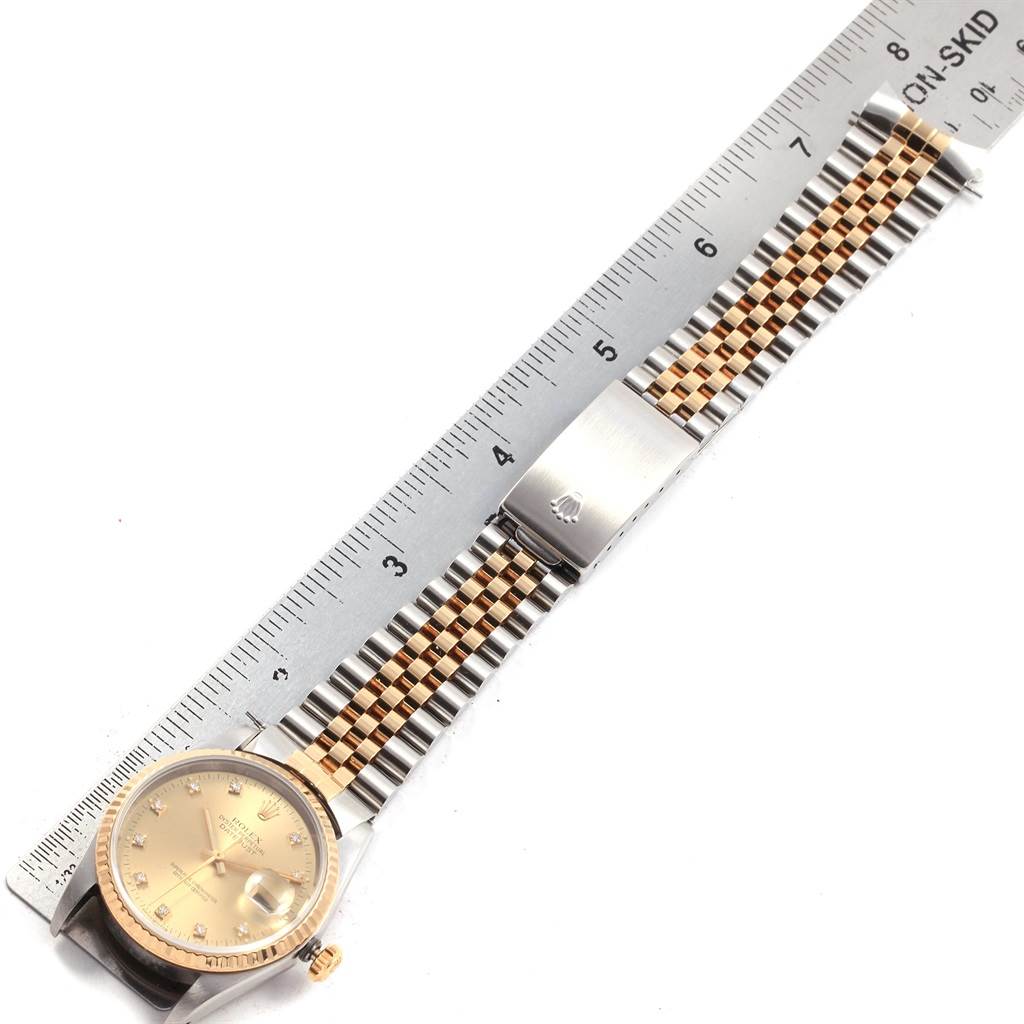 The image shows a top-down view of a Rolex Datejust 16233 Men's Steel and Gold (two tone) Champagne Dial 16233 Men's Steel and Gold (two tone) Champagne Dial, featuring its face, bezel, and two-tone bracelet with a deployment clasp.