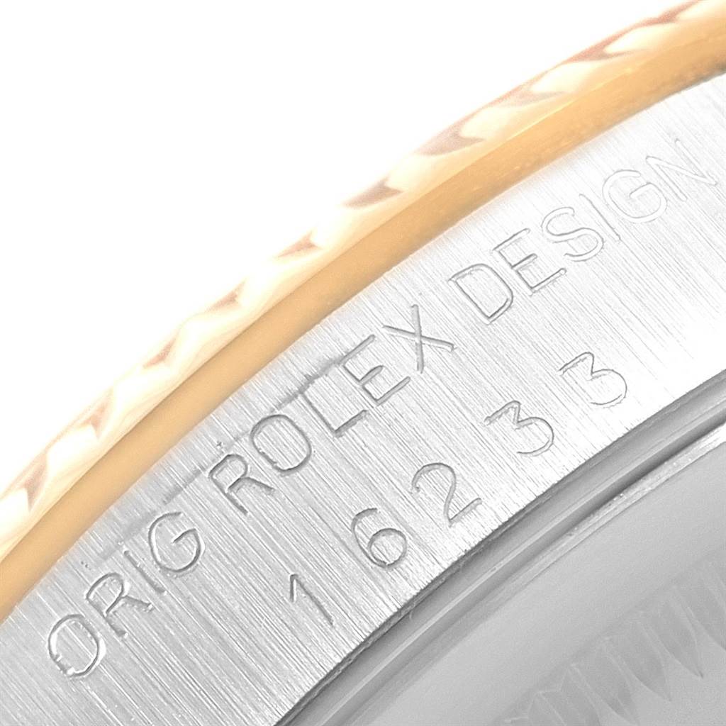 This close-up image shows the engraved model number and the edge of the bezel of the Rolex Datejust 16233 Men's Steel and Gold (two tone) Champagne Dial 16233 Men's Steel and Gold (two tone) Champagne Dial.