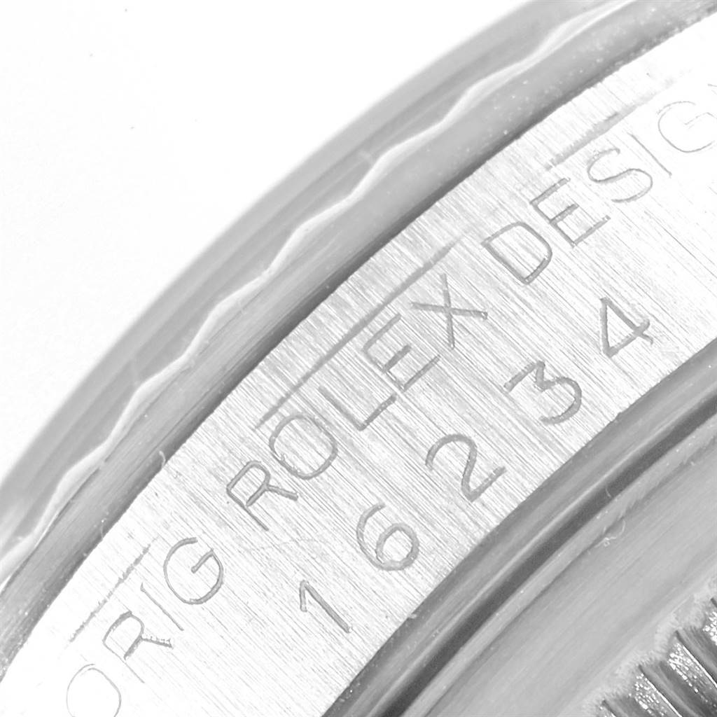 This image shows a close-up angle of the bezel and the engraved serial number on a Rolex Datejust 16234 Men
s Stainless Steel Silver Dial 16234 Men
s Stainless Steel Silver Dial watch.