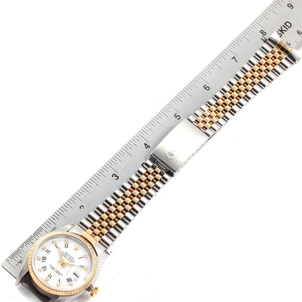 The image shows a Rolex Datejust 16233 Men's Steel and Gold (two tone) White Dial 16233 Men's Steel and Gold (two tone) White Dial watch laid flat with the face and bracelet's clasp visible alongside a ruler.