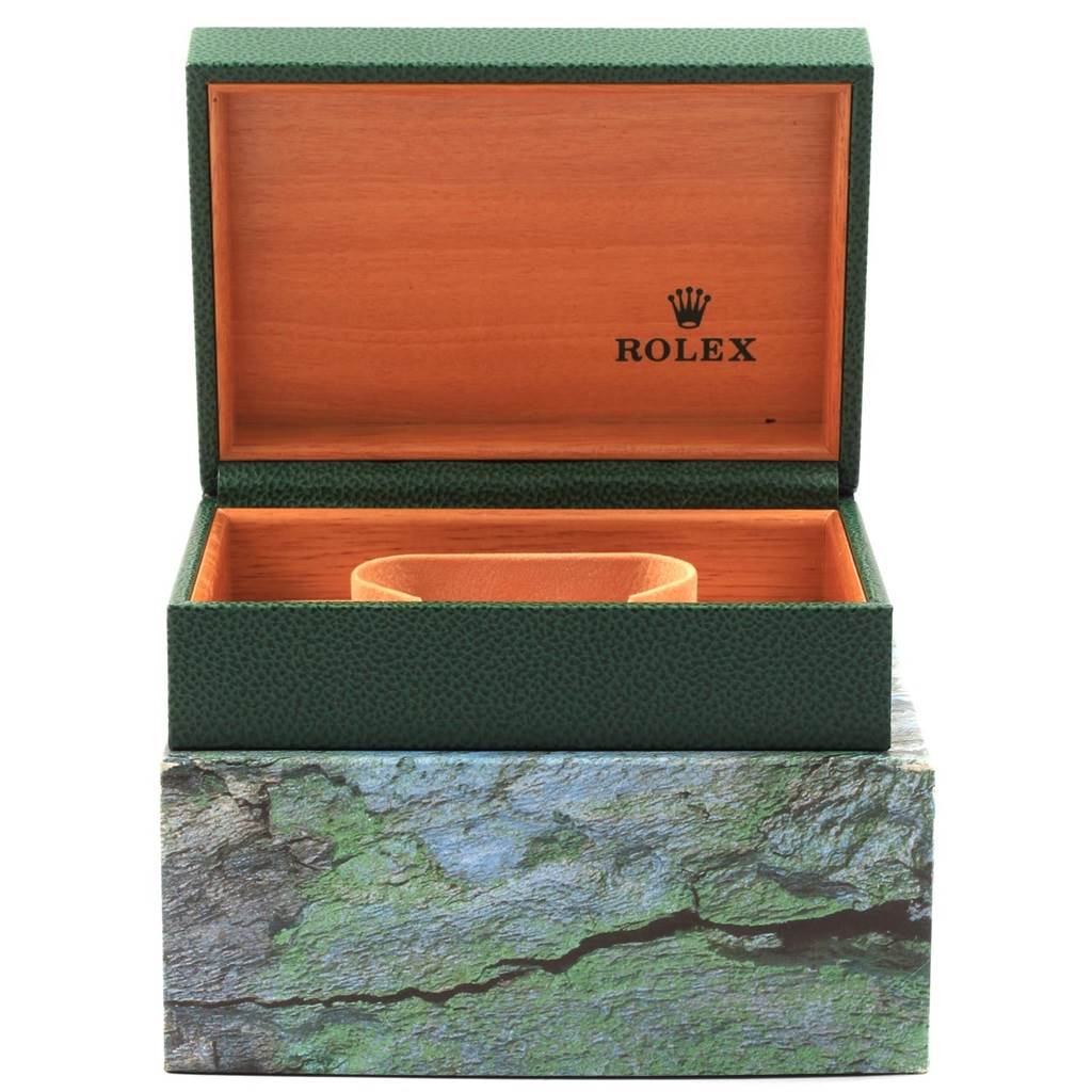 The image shows an open Rolex Datejust 16233 Men's Steel and Gold (two tone) White Dial 16233 Men's Steel and Gold (two tone) White Dial watch box with green exterior and wooden interior, featuring a cushion for the watch.