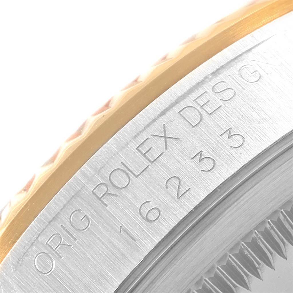 The image shows a close-up of the side of the Rolex Datejust 16233 Men's Steel and Gold (two tone) White Dial 16233 Men's Steel and Gold (two tone) White Dial watch case with the model number and design engraving.