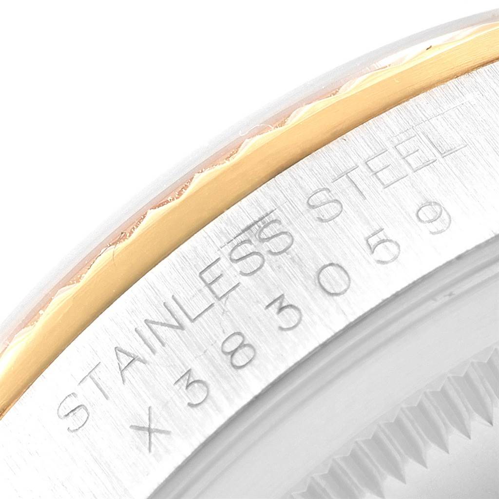 The image shows a close-up of the side of a Rolex Datejust 16233 Men's Steel and Gold (two tone) Champagne Dial 16233 Men's Steel and Gold (two tone) Champagne Dial watch case, highlighting the stainless steel engraving and part of the bezel.