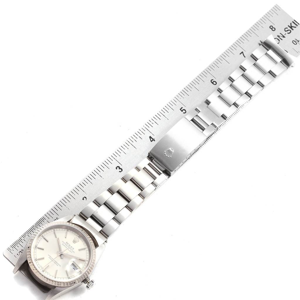 The Rolex Datejust 16234 Men
s Stainless Steel Silver Dial 16234 Men
s Stainless Steel Silver Dial watch is shown from a top-down angle, displaying the dial, bezel, and metal bracelet with a clasp.