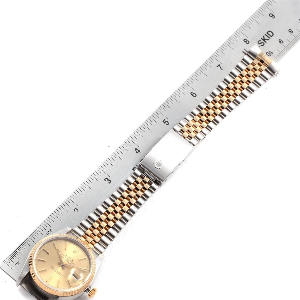 The image shows a Rolex Datejust 16233 Men's Steel and Gold (two tone) Champagne Dial 16233 Men's Steel and Gold (two tone) Champagne Dial watch laid flat with both the face and the bracelet, next to a ruler for scale.