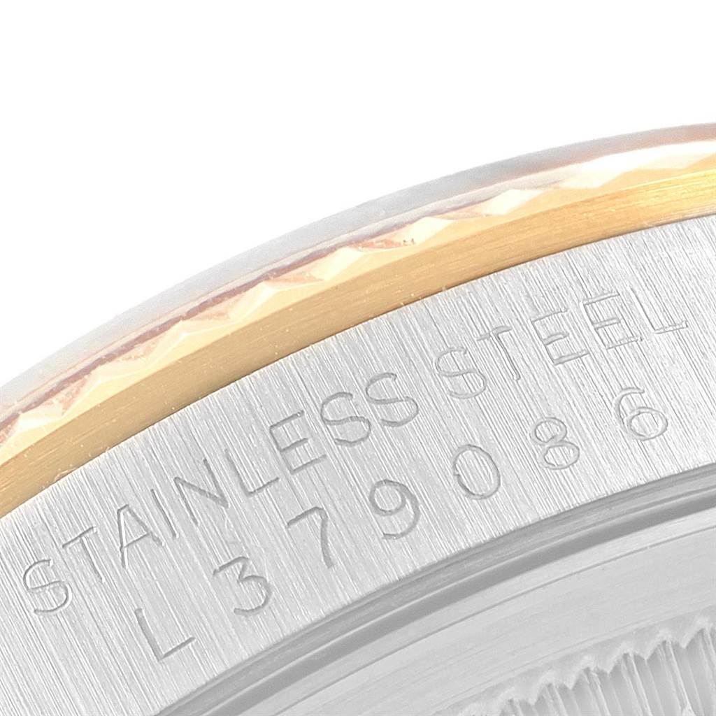 This close-up image shows the serial number and "STAINLESS STEEL" engraving on the case edge of a Rolex Datejust 16233 Men's Steel and Gold (two tone) Champagne Dial 16233 Men's Steel and Gold (two tone) Champagne Dial.