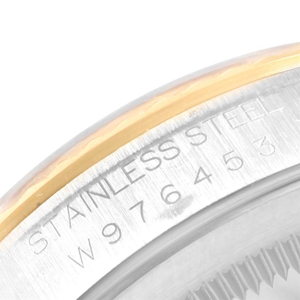 This image shows a close-up of the engraved stainless steel and bezel of a Rolex Datejust 16233 Men's Steel and Gold (two tone) White Dial 16233 Men's Steel and Gold (two tone) White Dial watch.