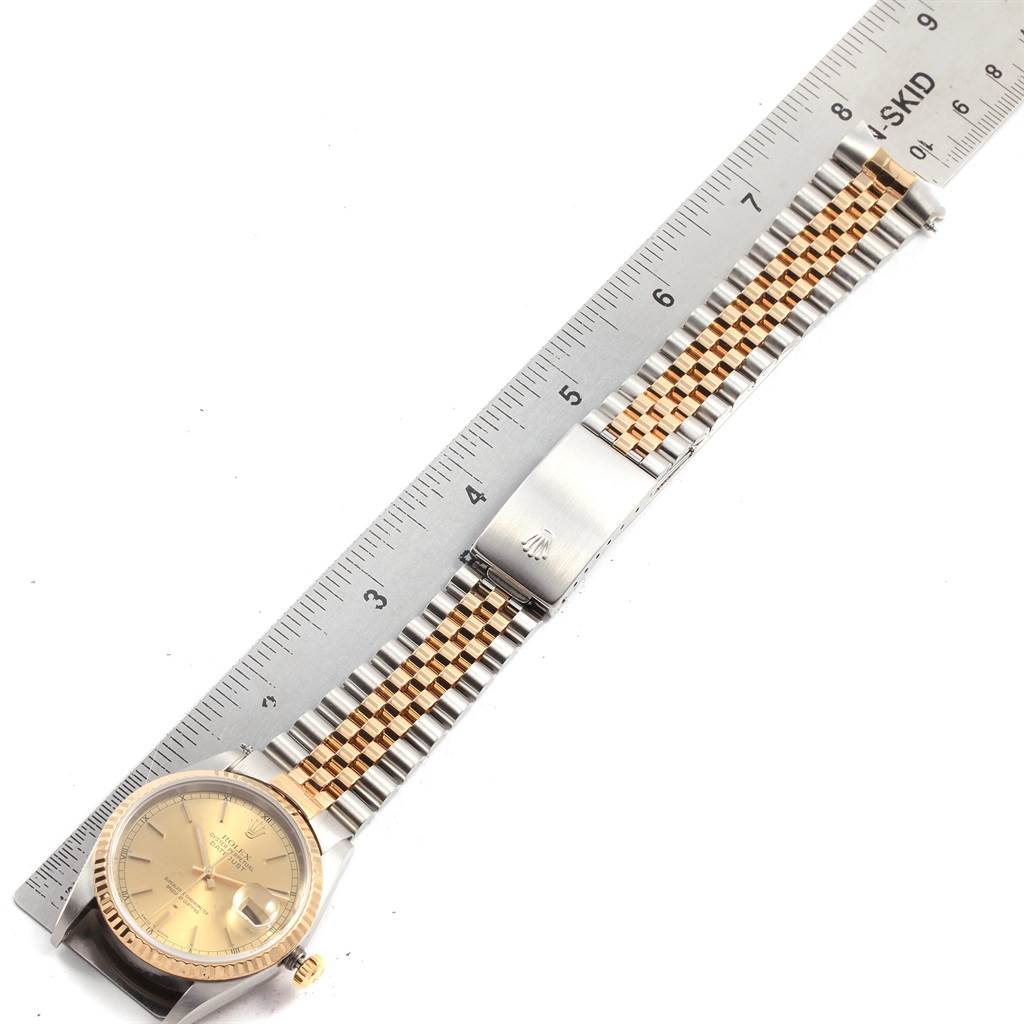 The image shows an aerial view of a Rolex Datejust 16233 Men's Steel and Gold (two tone) Champagne Dial 16233 Men's Steel and Gold (two tone) Champagne Dial watch, highlighting its face, bezel, bracelet, and clasp.