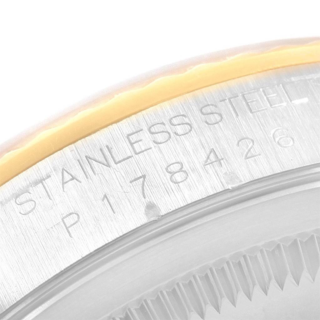 This is a close-up view of the case back and edge of the bezel of a Rolex Datejust 16233 Men's Steel and Gold (two tone) Champagne Dial 16233 Men's Steel and Gold (two tone) Champagne Dial, showing the "STAINLESS STEEL" engraving and part of the serial number.