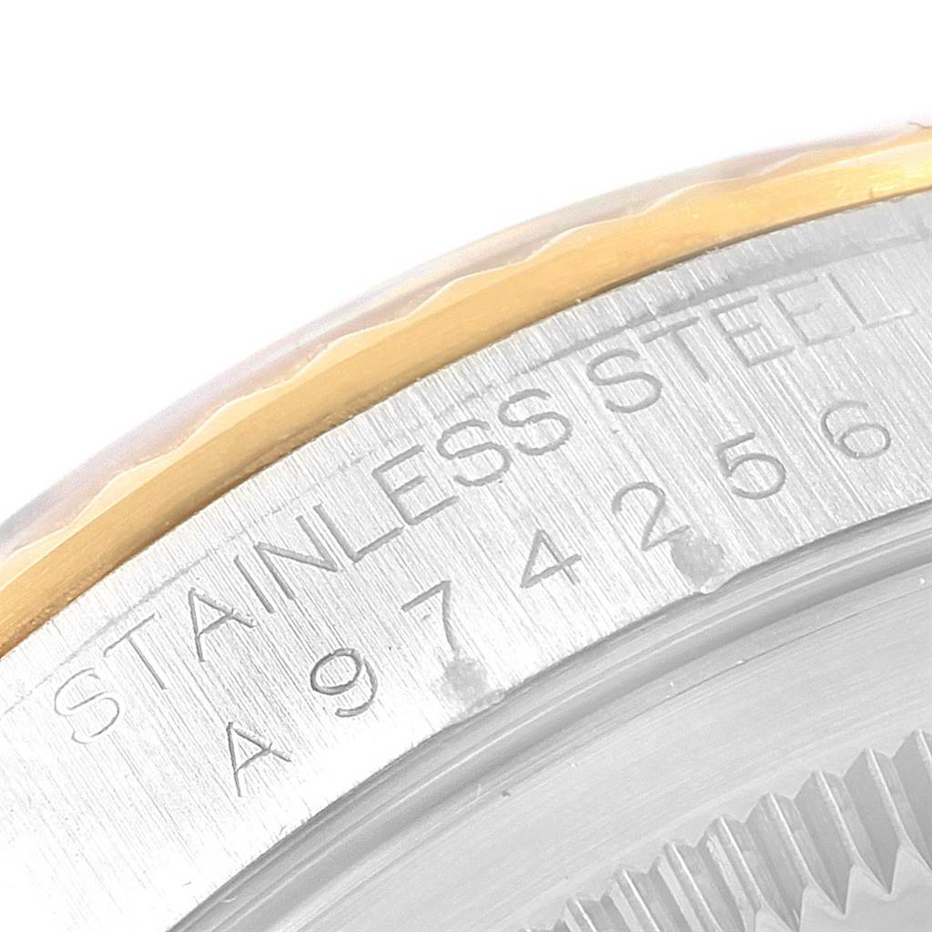 This image shows a close-up of the serial number and the "Stainless Steel" engraving on the case of a Rolex Datejust 16233 Men's Steel and Gold (two tone) Beige Dial 16233 Men's Steel and Gold (two tone) Beige Dial watch.